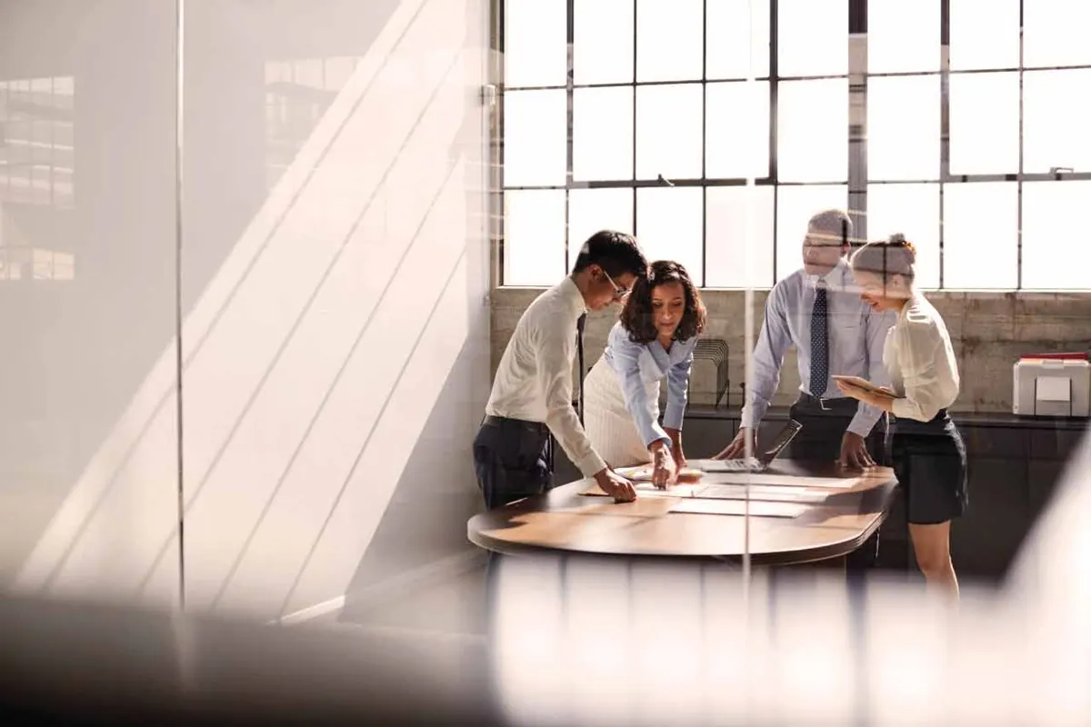 Team reviewing plans at a meeting table